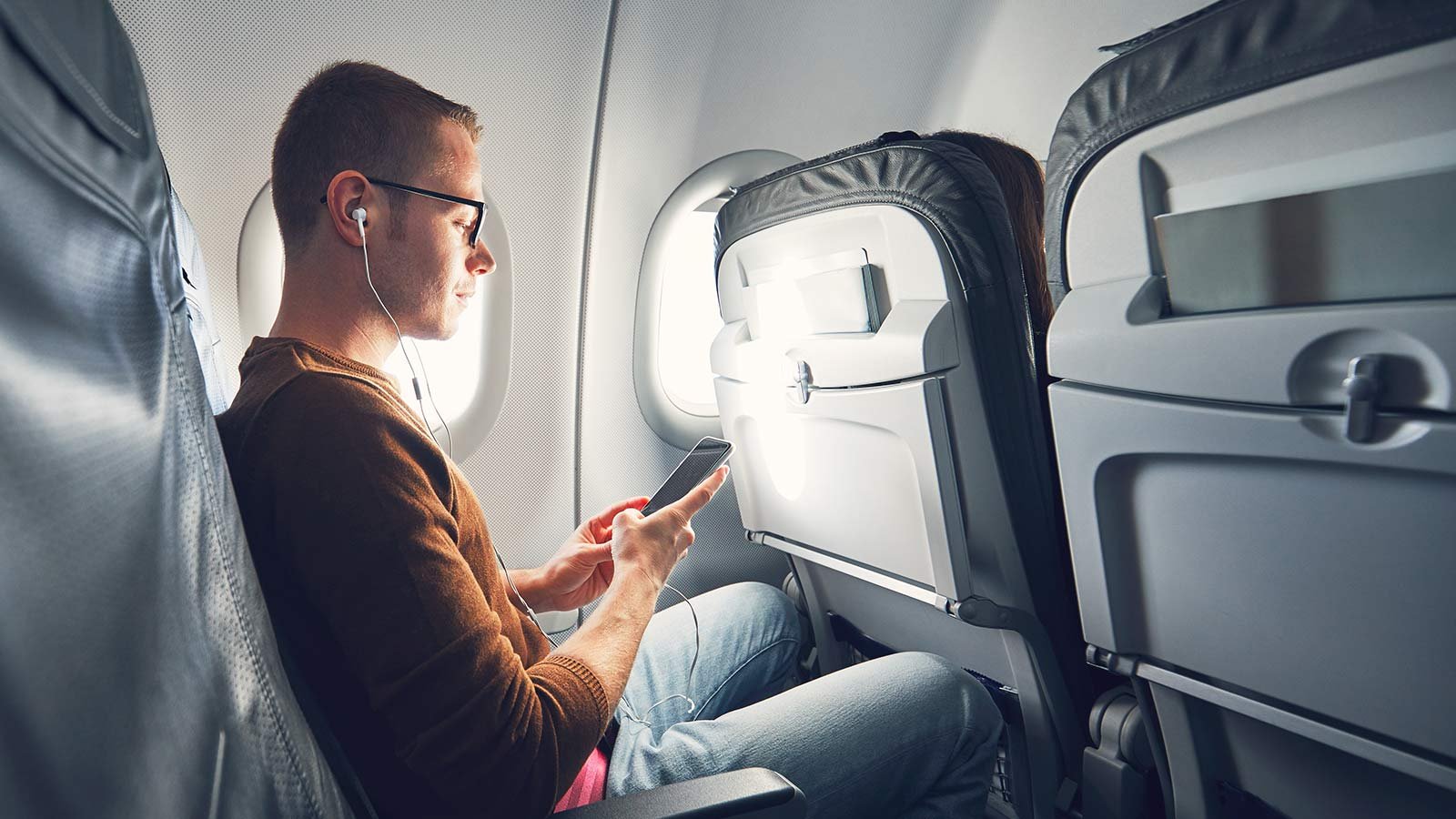 Man listening to music during flight