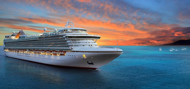 Luxury cruise ship sailing to port on sunrise
