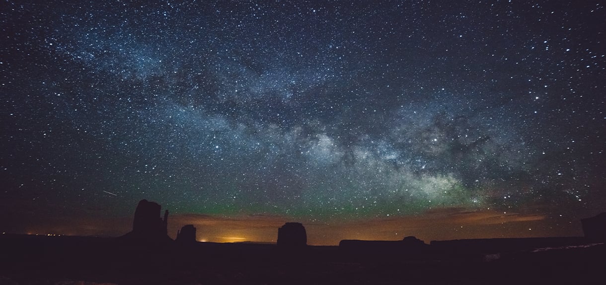 Milky Way and stars above desert rock silhouettes